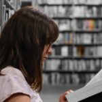 woman reading book with library background