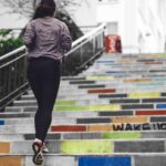 woman running upstairs outside colorful