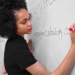 woman writing on whiteboard